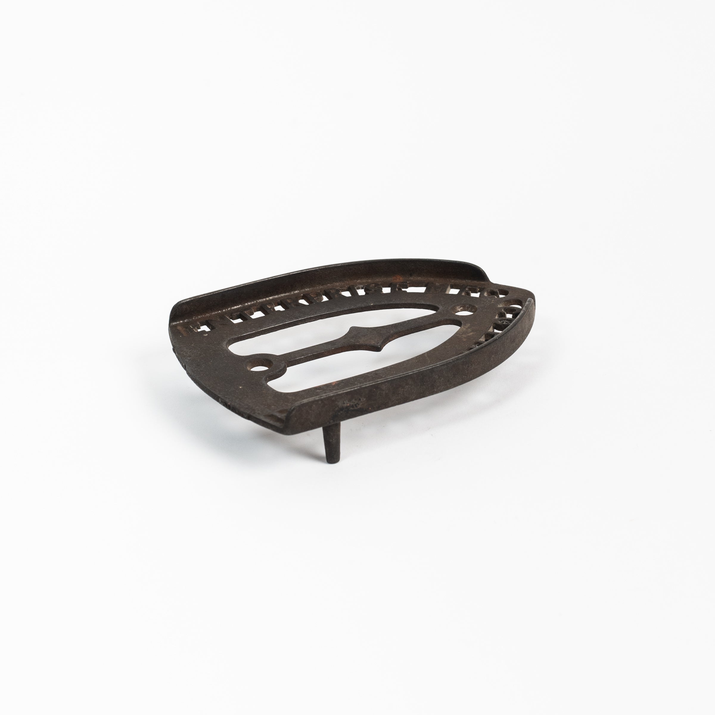 Dessous de plat en fer vintage triste