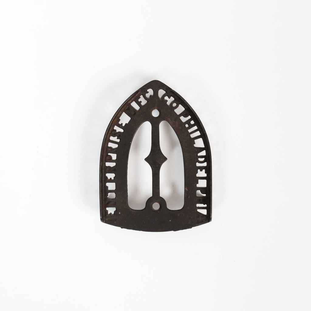 Dessous de plat en fer vintage triste