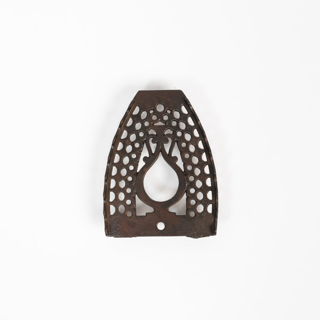 Dessous de plat en fer vintage triste