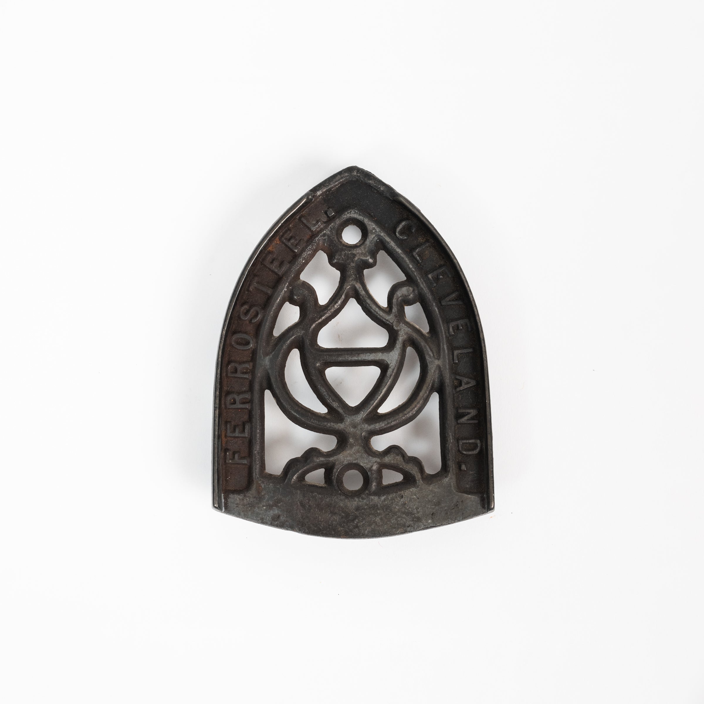 Dessous de plat en fer vintage triste